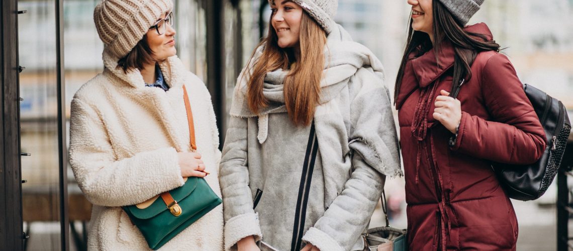 Three girls friends student in winter outfit outside the street